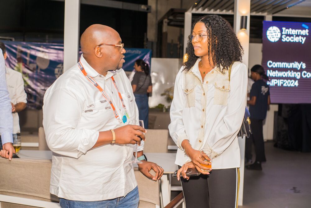 A man and a woman talking at the event